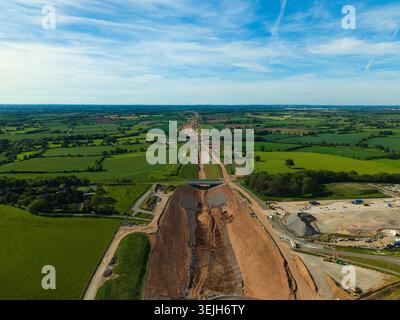Aerial view of HS2 High Speed Rail Civil Engineering Works cutting through green countryside and fields under a blue sky Kenilworth, England, United K Stock Photo