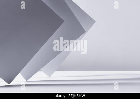 Abstract white grey minimalist background with asymmetric standing sheets with perspective, light and shadow, stripes as border, Stock Photo