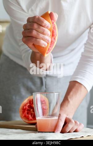 Hand squeezed grapefruit juice. Vitamin C is vital for keeping the immune system healthy. Useful for colds.Detox drink, fitness, Stock Photo