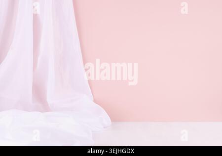 Abstract modern minimal scene or interior with soft light pastel pink wall, white silk curtain and white wood table of floor. Ba Stock Photo