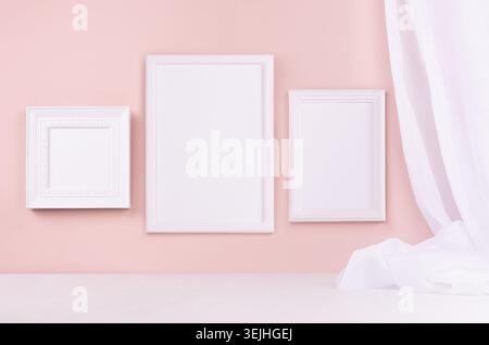 Minimal elegant gallery for display portfolio - three blank  rectangle  photo frames with flow silk curtain hanging on pink wall Stock Photo