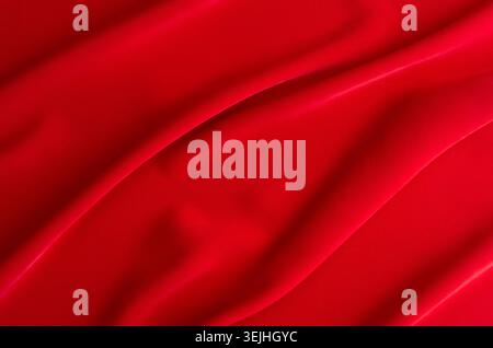 Red silk wavy background. Passion backdrop for Valentines day. Stock Photo