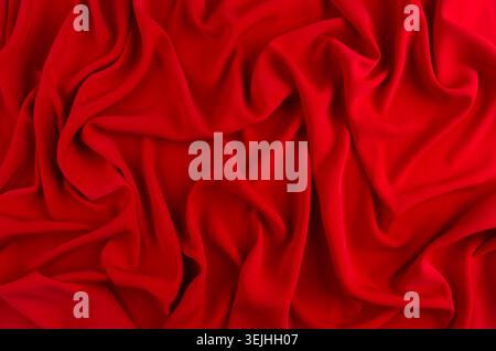 Red silk wavy background. Passion backdrop for Valentines day. Stock Photo