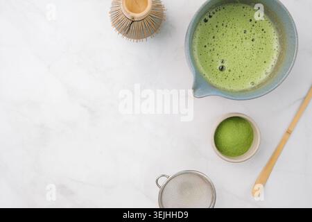 Traditional matcha kit, Bamboo whisk and beverage on marble background in the kitchen Stock Photo