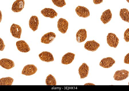 Brown slices rye croutons isolated on white background, top view, pattern. Stock Photo