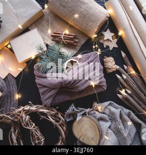 Christmas holiday gift wrapped in cloth in the style of Furoshiki on a dark background Stock Photo