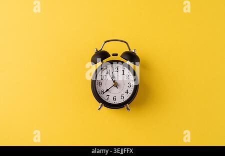 White retro alarm clock isolated on yellow background with copy space Stock Photo