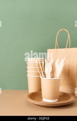 Disposable eco friendly tableware on green background Stock Photo