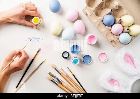 Easter background with eggs with pastel paints, top view flat lay Stock Photo