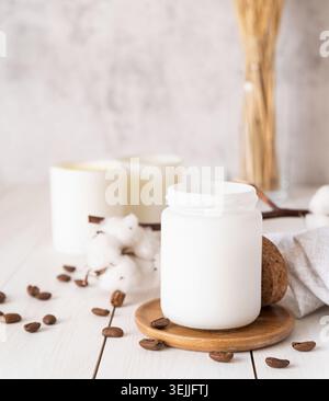 Beautiful burning candles with cotton flowers and coffee beans on white wooden background Stock Photo