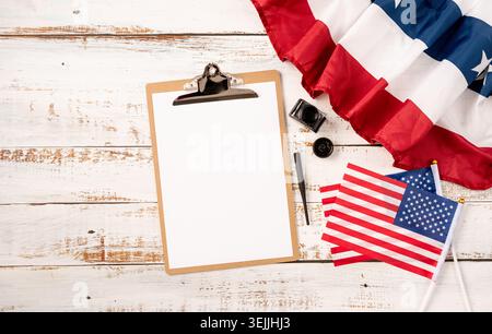 Blank paper on craft clipboard for mockup design with USA flag and ink top view flat lay Stock Photo