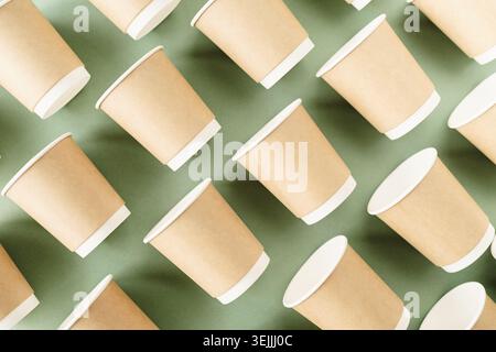 Disposable paper cups pattern top view on green background Stock Photo
