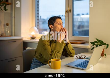 Exhausted pensive senior businesswoman suffering from burnout at work, dealing with problems. Stock Photo