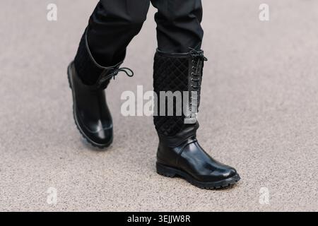 Milan, Italy - January, 18, 2025: Black quilted leather boots street style Stock Photo