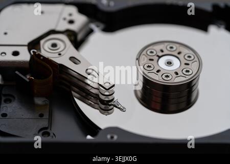 Opened hard disk after disassembly during repair or service, macro shot. Computer laptop HDD inside. Stock Photo