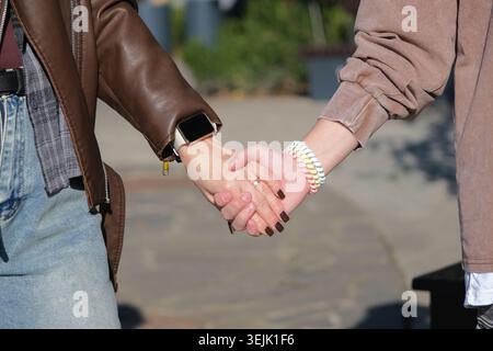 Mother and teen girl holding hands Stock Photo