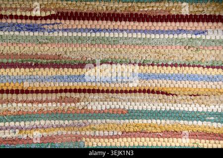 Full frame background of a colorful woven striped rag rug texture. Stock Photo