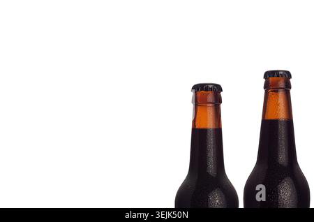 Brown porter beer in bottles with water drops isolated on white background. Stock Photo