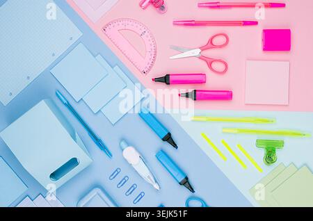 Back to school background - colored different stationery set on soft neon blue, pink, green paper background, top view. Stock Photo