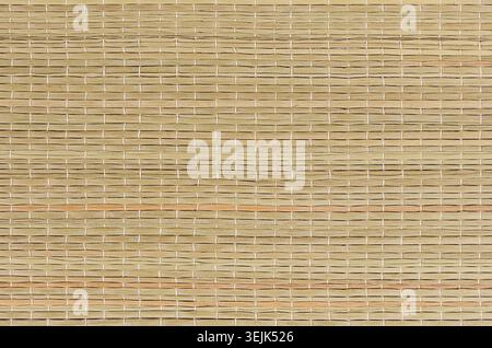 Beige natural mat of dry wicker grass as texture, background. Stock Photo