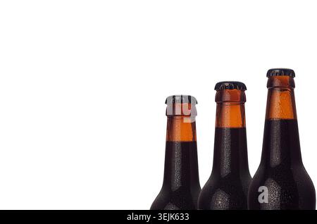 Wet cold brown dark beer bottles closeup, half bottle view, isolated on white background. Stock Photo