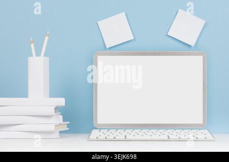 Fashion trendy office desk - white stationery, blank laptop computer on soft light blue background. Stock Photo