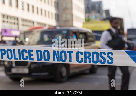 London, UK. 29th May 2026, A Metropolitan Police cordon tape reading POLICE DO NOT CROSS stretches across the Strand near Charing Cross station, central London,. A black London taxi is stopped behind the cordon as an officer manages the scene. Emergency services closed the road following an incident on one of central London's busiest thoroughfares.  Credit:xiu bao/Alamy Live News Stock Photo