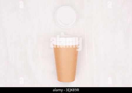 Coffee kraft paper cup and blank cap on light wood board, top view. Mockup for branding identity, advertising and design concept Stock Photo