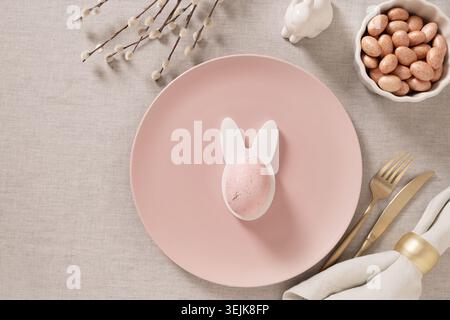 Minimal Easter table setting with empty plate and eggs Stock Photo