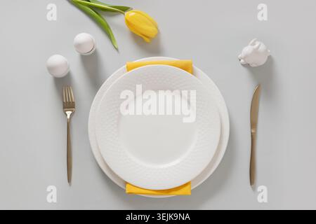 Easter table setting with plate eggs and tulip Stock Photo