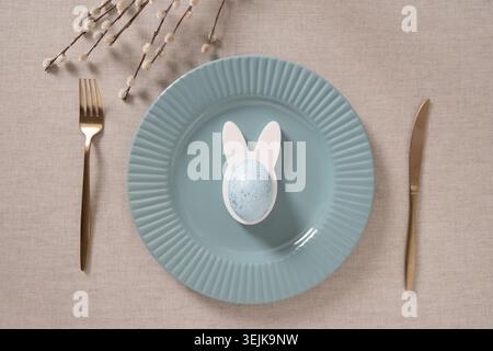 Easter table setting with blue plate and willow branches Stock Photo