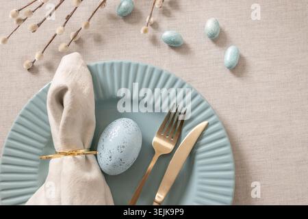 Minimal Easter table setting with blue ceramic plate Stock Photo