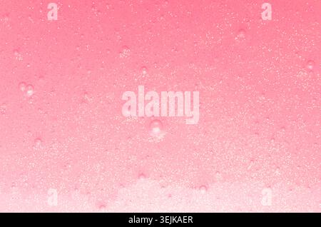 Soft light pink slime with gold glitter and small bubbles texture with gradient, abstract girlish background. Stock Photo