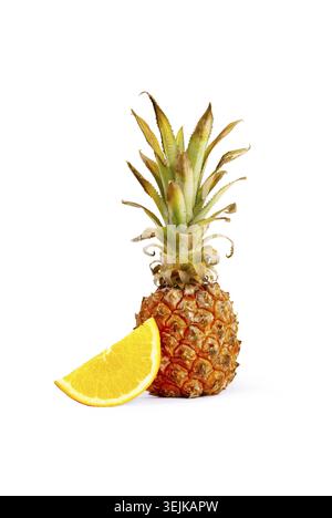 Fresh pineapple and orange slices arranged on a white background, vertical, no people Stock Photo