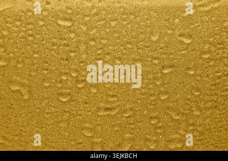 Golden shimmer and glitter wet texture with drops. Rich golden background. Stock Photo