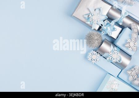 Christmas background - gift boxes in pastel blue and silver metallic color with ribbons and bows, decorations, top view, copy sp Stock Photo