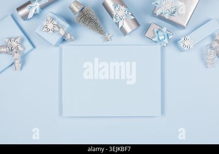 Christmas mock up for advertising and design - blank paper, gift boxes in pastel blue and silver metallic color with ribbons and Stock Photo