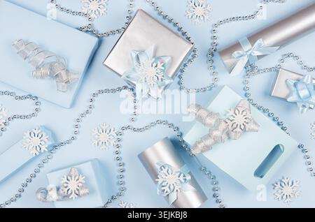 Christmas gift boxes in pastel blue and silver metallic color with ribbons and bows, decoration, top view, pattern, festive back Stock Photo