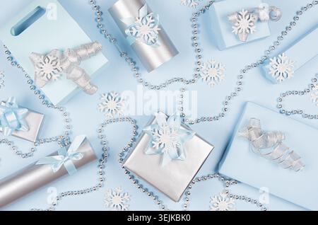 Christmas gift boxes in pastel blue and silver metallic color with ribbons and bows, decoration, top view, pattern, festive back Stock Photo