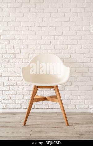 White chair on a brick wall background Stock Photo
