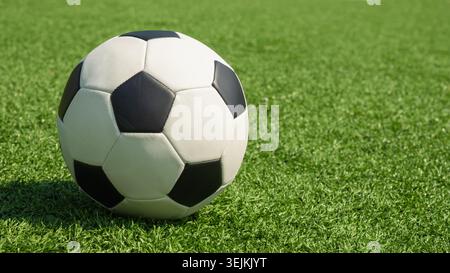 Soccer ball on green grass field close up Stock Photo