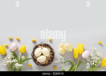 Easter mock up with pastel yellow pink eggs on gray background. Stock Photo