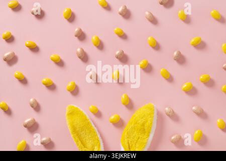 Easter with chocolate eggs decorated yellow bunny ears, greeting card. Stock Photo