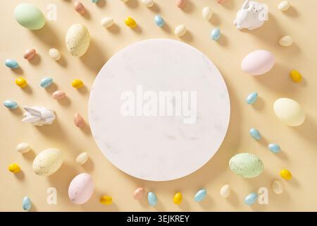 Easter frame with sweet chocolate eggs, painted eggs on yellow. Stock Photo