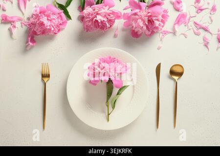 Elegance spring table setting with pink peony flowers. Stock Photo