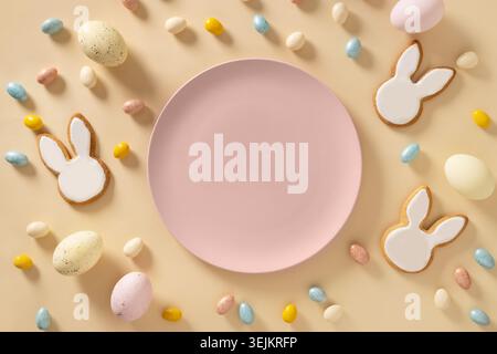 Easter bunny cookies on beige background. Top view. Stock Photo