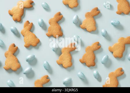 Easter cookies shaped of bunny and chocolate sweets candy as eggs . Stock Photo