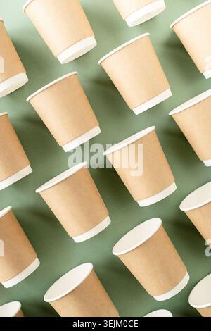 Disposable paper cups pattern top view on green background Stock Photo