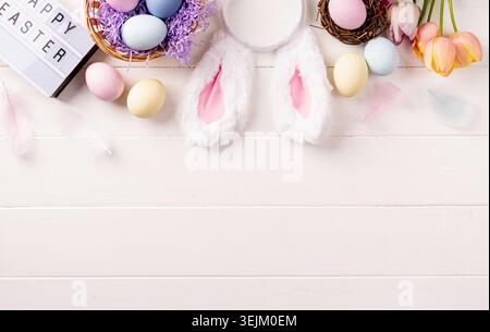 Easter holiday background with decorations on white wooden backdrop Stock Photo