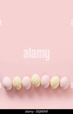 Easter pattern with pastel colorful eggs on pink background. Stock Photo